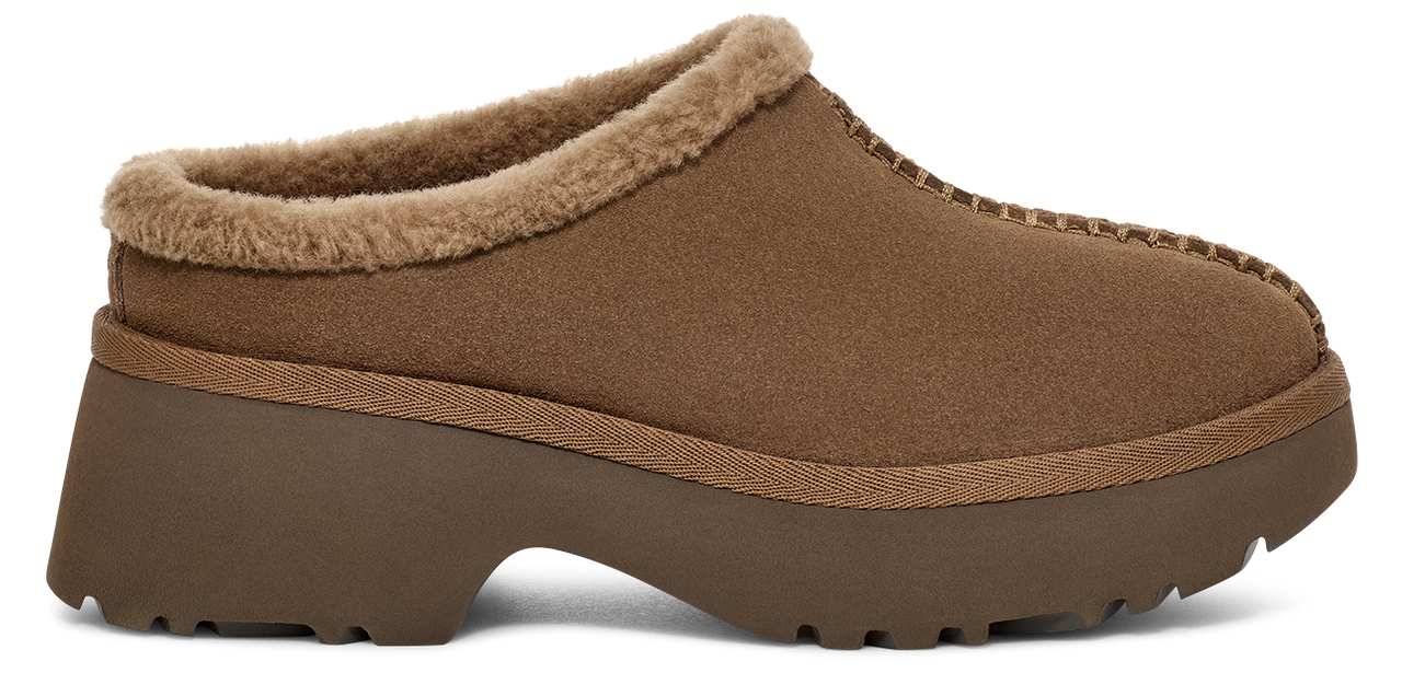 A brown slipper with a platform sole and faux fur trim.