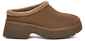 A brown slipper with a platform sole and faux fur trim.