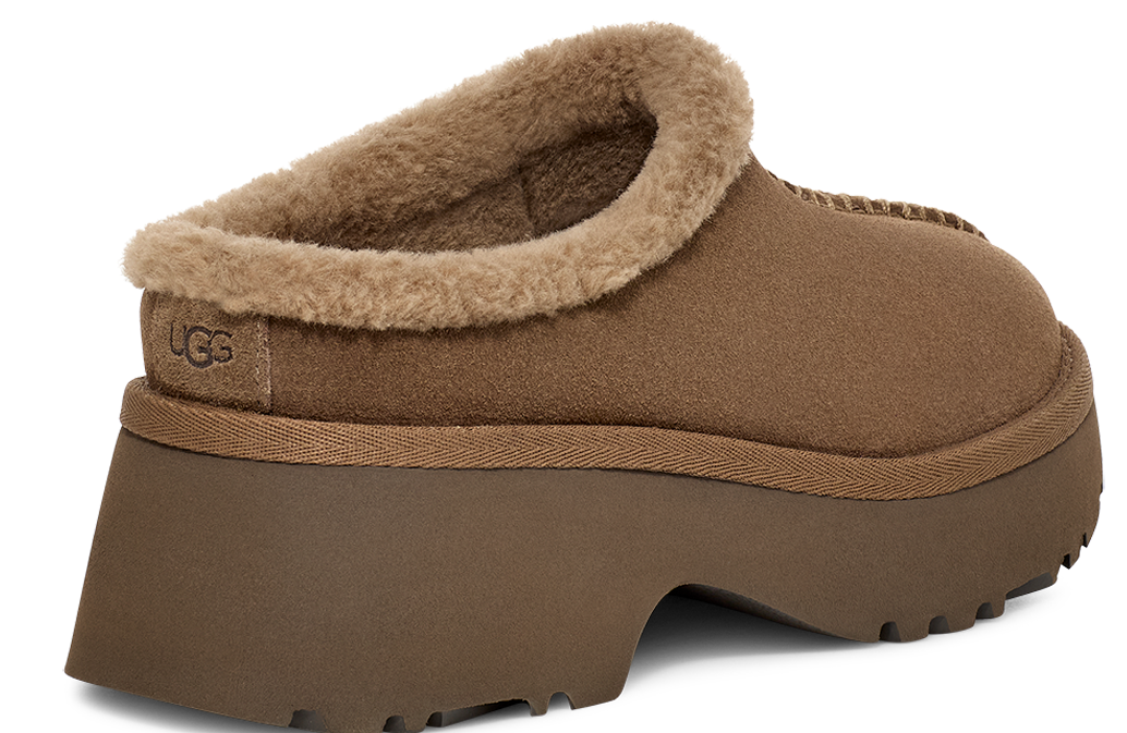 Brown suede platform clog slipper with fur trim and visible logo.