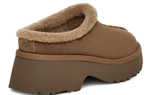 Brown suede platform clog slipper with fur trim and visible logo.