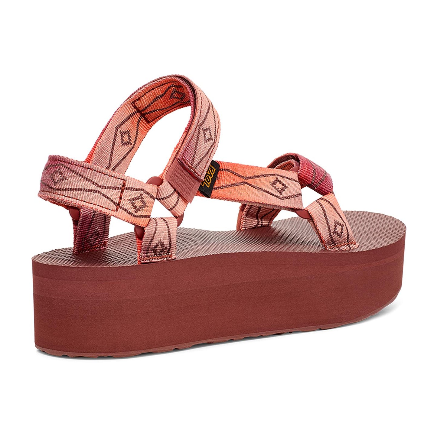 A platform sandal with patterned coral-colored straps.