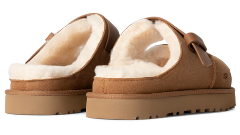 Tan-colored slipper with sheepskin lining and a thick platform sole.