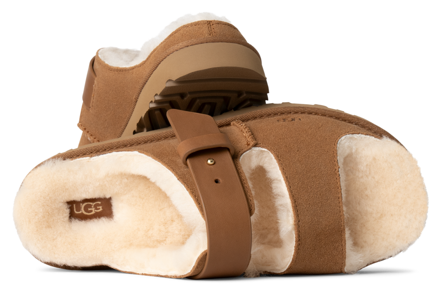 Two brown sheepskin slippers with a brown strap and the word UGG visible.