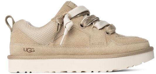 A tan shoe with thick, white laces and a white sole with visible UGG logo.