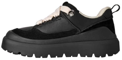 A black chunky-soled sneaker with black suede and leather panels, cream-colored laces, and a cream-colored interior lining, shown from a side profile.