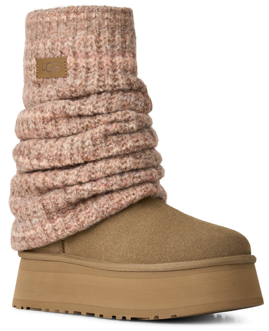 A tan suede platform boot featuring a tall, ribbed knit cuff in a soft, speckled dusty pink hue, with a small leather tag displaying UGG branding on the cuff.