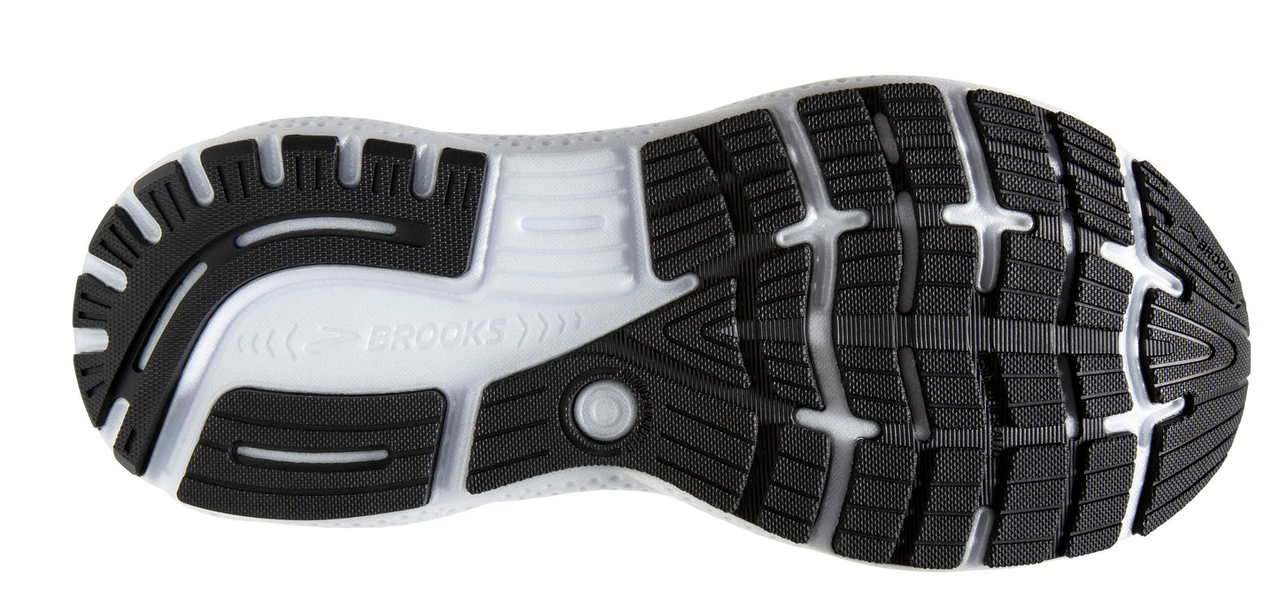 The sole of a running shoe featuring black rubber traction pads separated by a clear midsole.