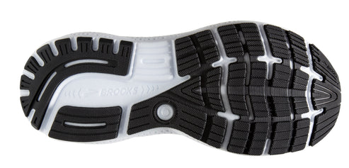 The sole of a running shoe featuring black rubber traction pads separated by a clear midsole.