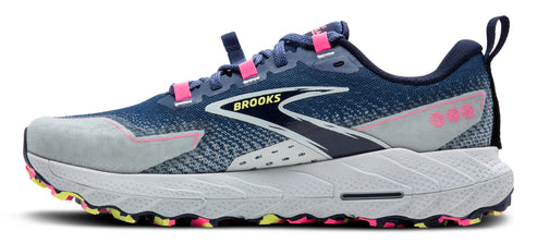 A side view of a trail running shoe with a navy and gray upper, pink accents, a white midsole, and a multicolored outsole.