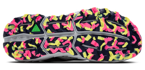 Sole of a running shoe with navy, pink, and yellow geometric patterns.