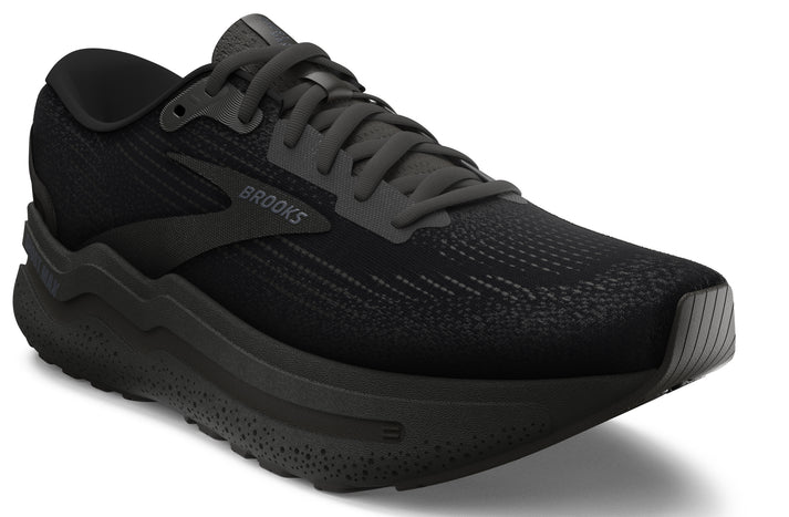 Black running shoe with a thick textured sole and laces. The word BROOKS is visible on the side.