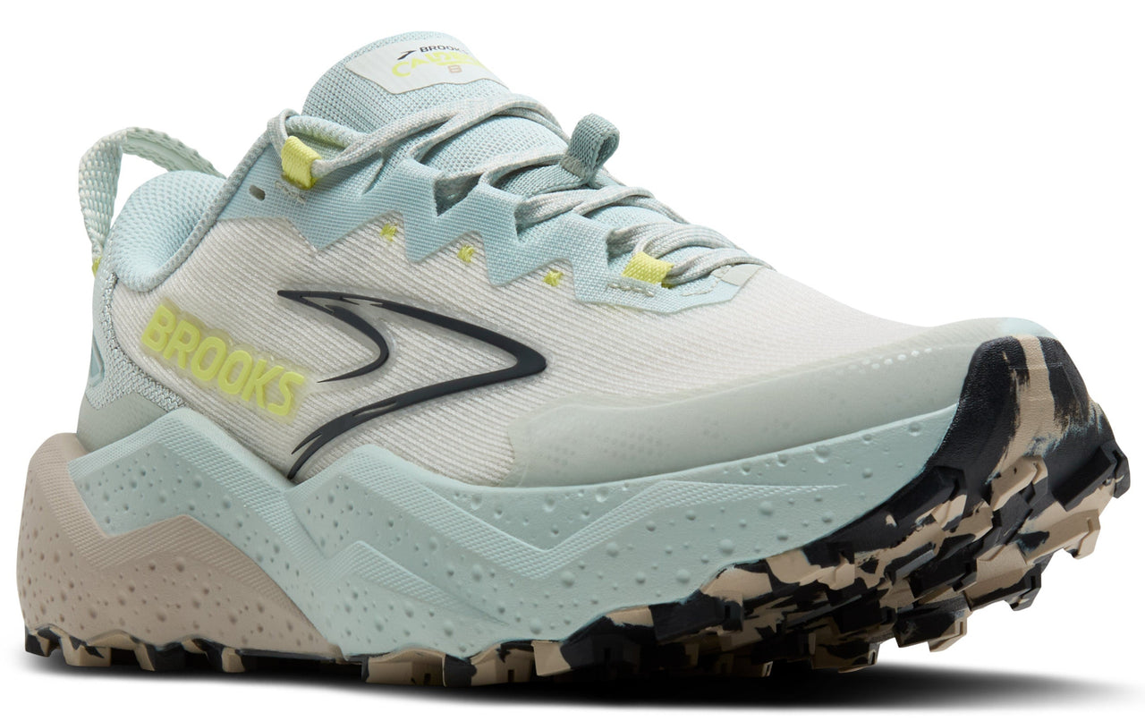 Low-cut trail running shoe in off-white with aqua accents, bright yellow branding, black logo, and high-traction sole.