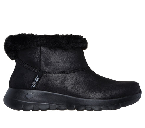 Black slip-on ankle boot with faux fur trim and flexible sole with text "SKECHERS SLIP-INS".