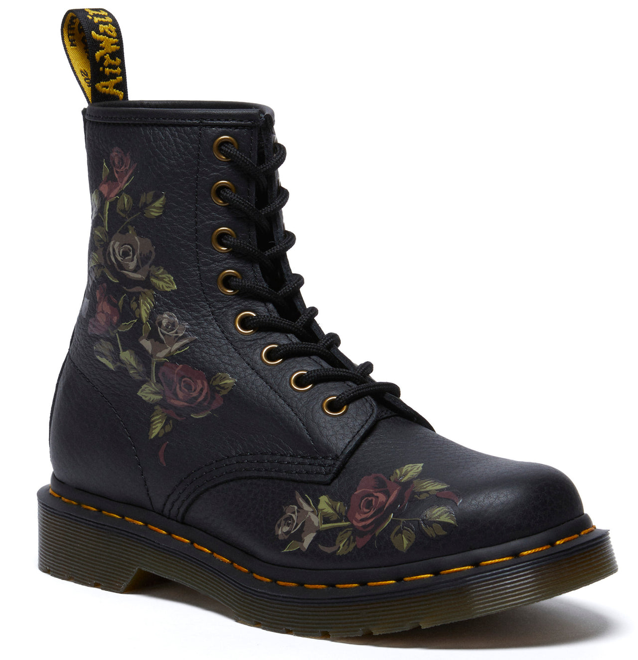 A black ankle boot with a yellow pull loop and floral print, laces, and yellow stitching along the sole.