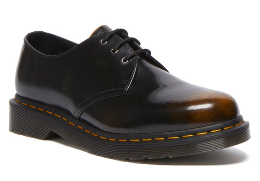Leather upper dress shoe with black laces and a rubber sole.