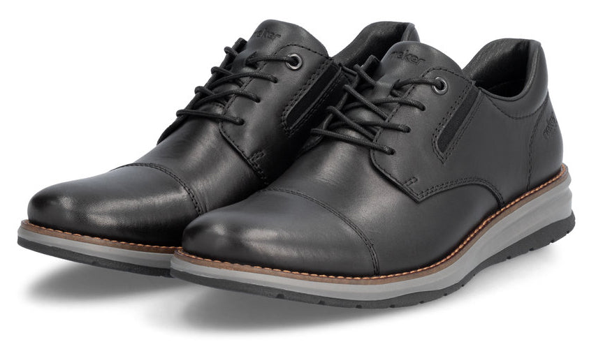 A pair of black leather dress shoes with black laces and a grey sole.