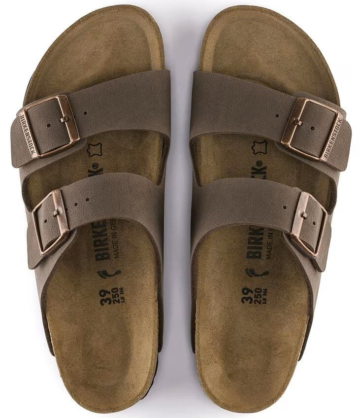 Two brown leather sandals with adjustable straps and metal buckles, seen from above.