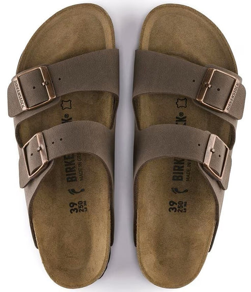 Two brown leather sandals with adjustable straps and metal buckles, seen from above.