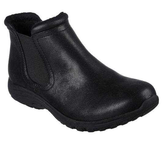 A black ankle boot with elastic side panels and a low heel, lined with faux fur.