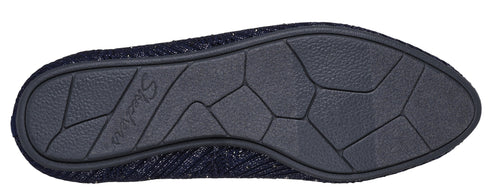 Close-up on the sole of a shoe, revealing a textured, patterned surface divided into geometric shapes.