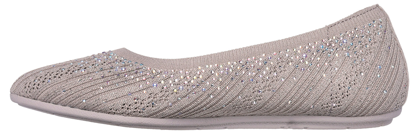 A light beige ballet flat with small glittery embellishments.