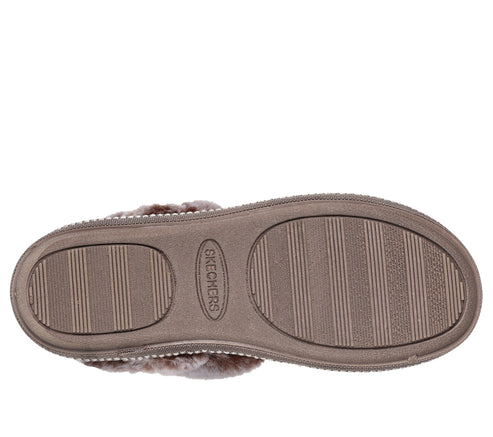 Shoe sole with oval traction pads and textured surface.