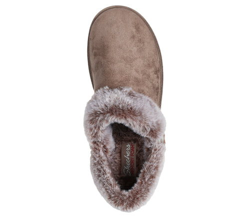 Taupe colored slipper with faux fur lining seen from above.