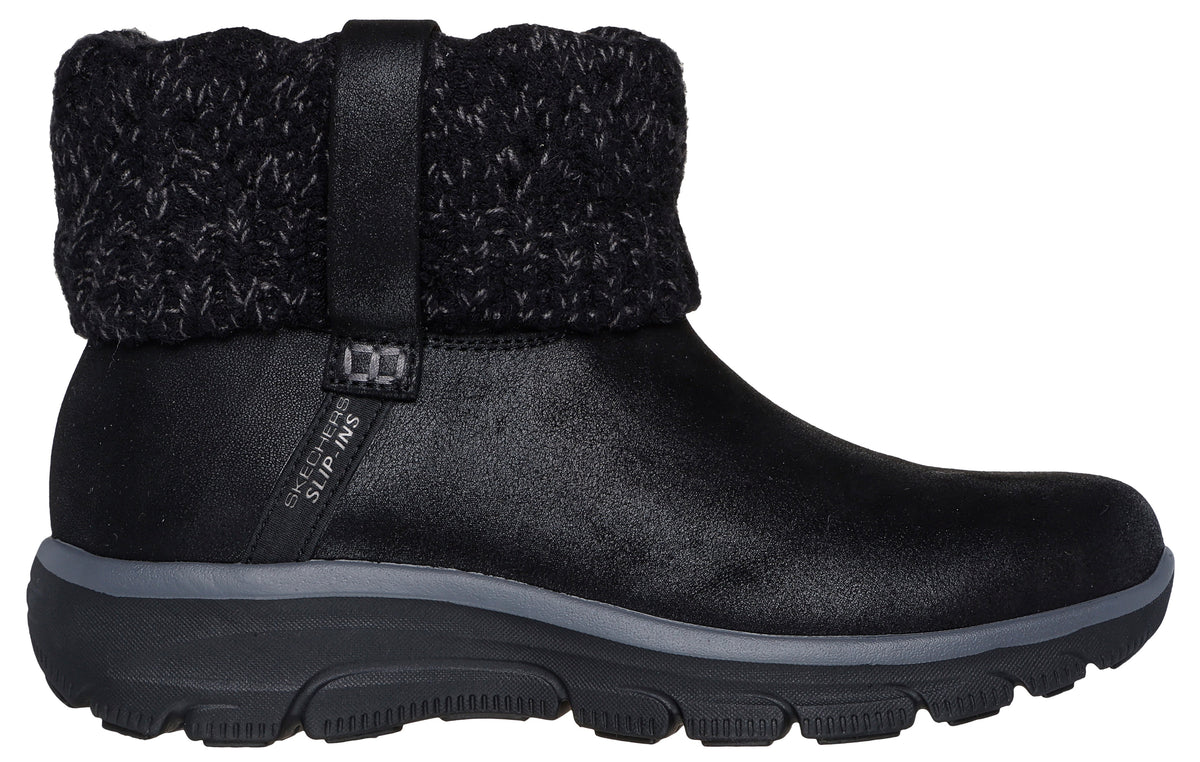 A black Skechers Slip-ins ankle boot with a textured knit cuff around the collar and a thick, dark gray and black rubber sole.