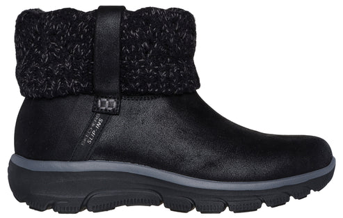 A black Skechers Slip-ins ankle boot with a textured knit cuff around the collar and a thick, dark gray and black rubber sole.