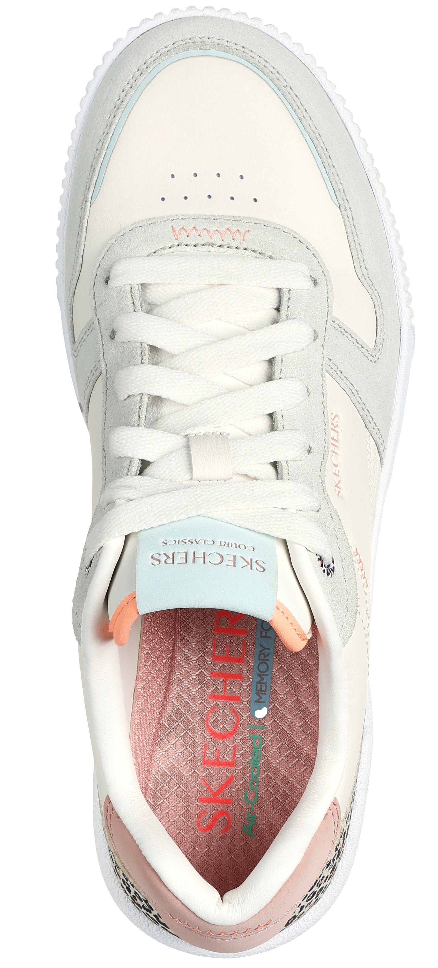 A low top sneaker with white laces, off white color, with a gray and peach colored insole.