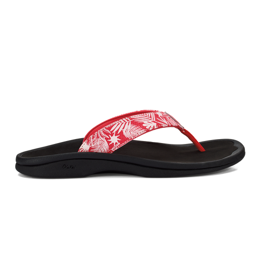 Red thong sandal with tropical print on the strap and a black sole.