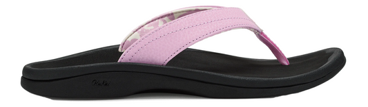 A pink sandal with a black sole.
