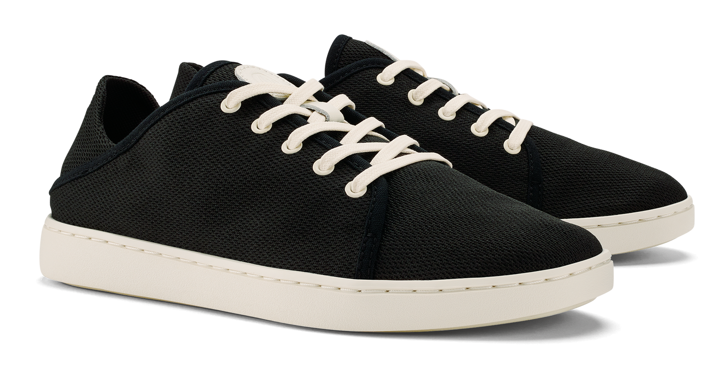 Pair of black low-top sneakers with off-white laces and soles.