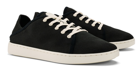 Pair of black low-top sneakers with off-white laces and soles.