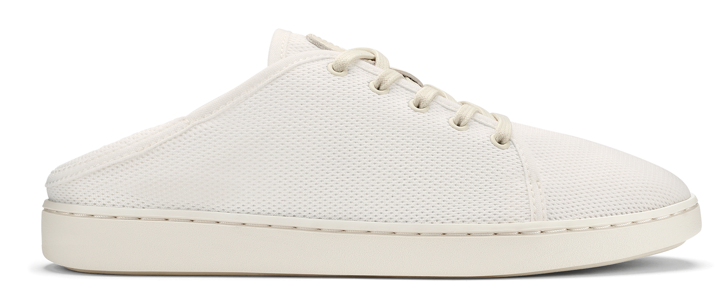 A white, low-top shoe with laces and a rubber sole.