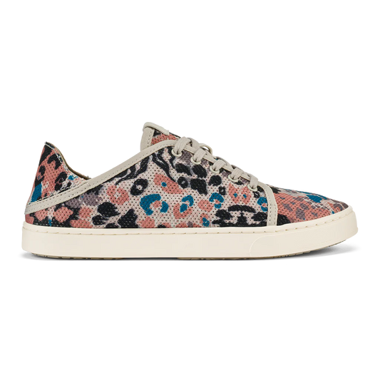 A side view of a sneaker with a colorful speckled print and cream-colored laces and sole.