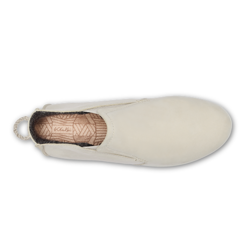 A top-down view of a cream-colored slip-on casual shoe with a woven-patterned insole featuring the visible text 'L.L.Bean' and a small braided pull tab at the heel.