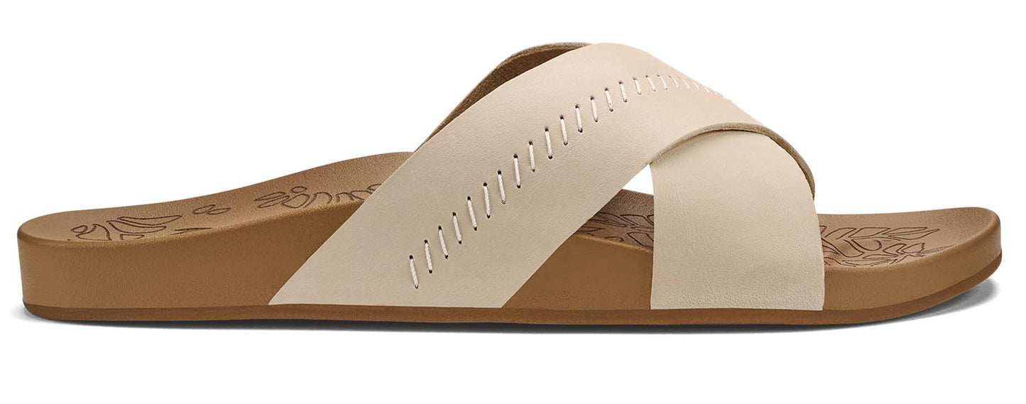 A cream-colored sandal with two crossing straps and decorative stitching on the upper strap.