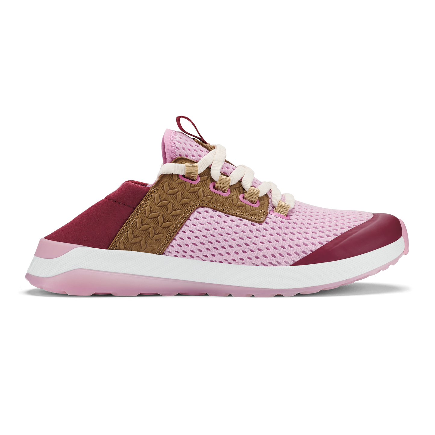 A slip-on style sneaker in pastel pink mesh with a tan suede-like mid-section featuring a woven pattern, dark berry-colored accents on the toe and heel, and a thick white and pink sole.