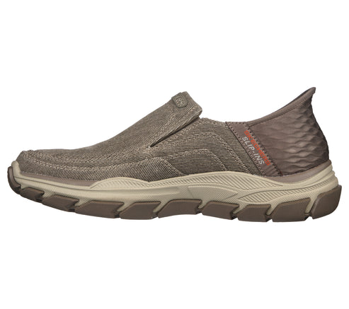 Taupe slip-on canvas shoe with a rugged sole and 'SLIP-INS' visible on the heel.