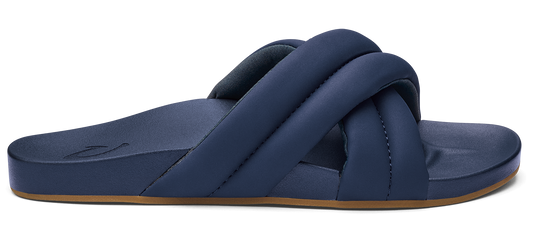 Navy blue slide sandal with wide, padded crisscross straps and a brown sole.
