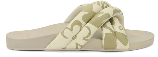 A beige slip-on sandal with two knotted straps patterned with beige shapes.