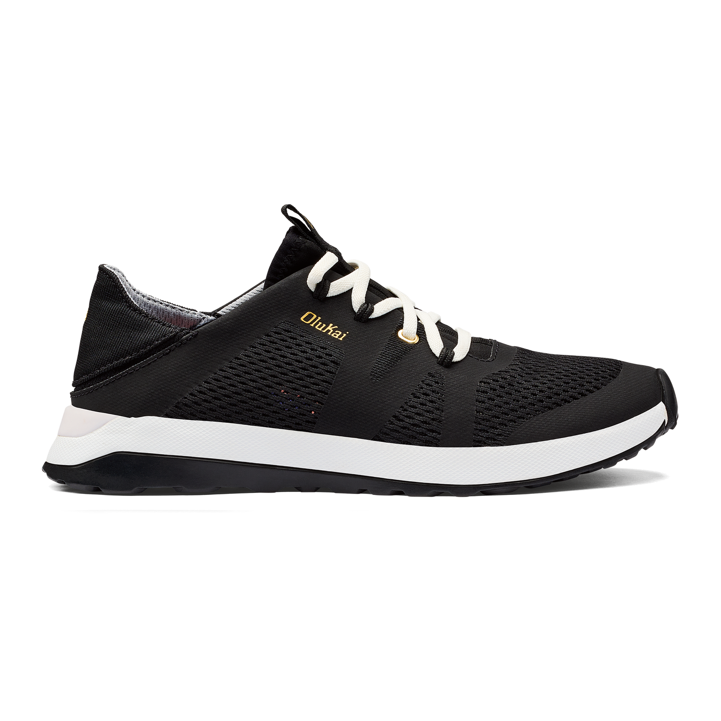 Black shoe with white laces and white midsole, with 'OluKai' in gold on side.