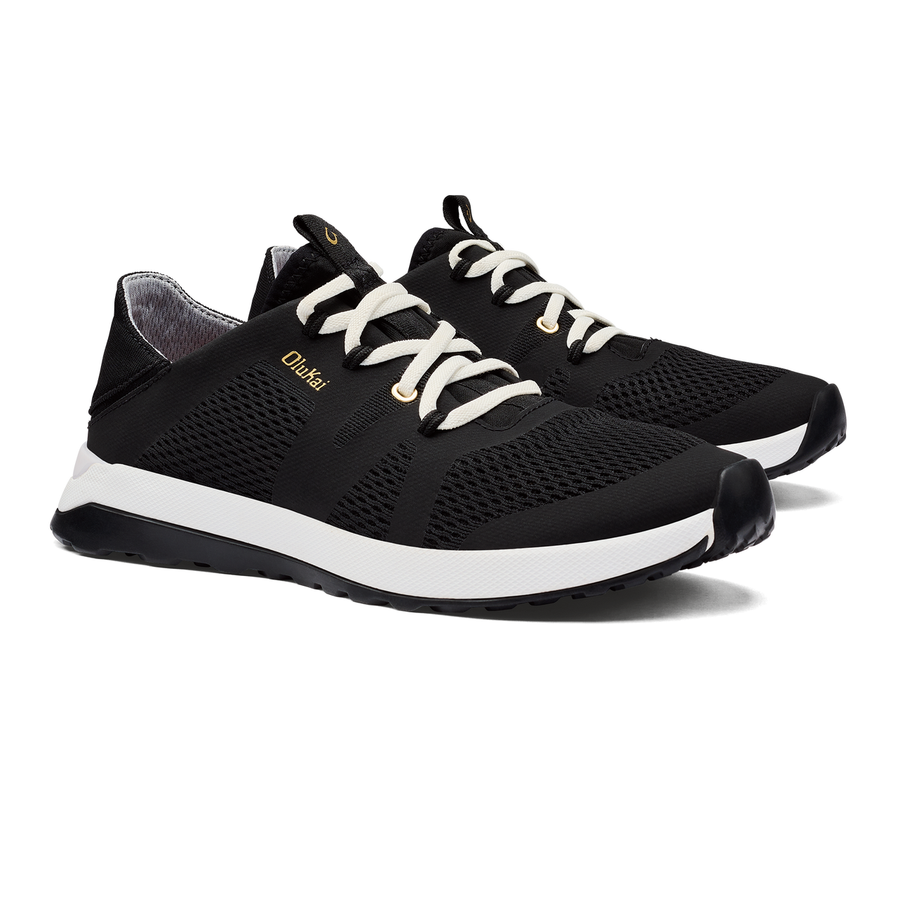 A pair of black running shoes with white laces and a white sole, with the word "OluKai" on the side.