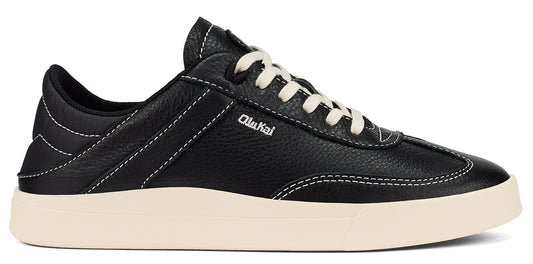 A black low-top sneaker with white laces and white stitching.