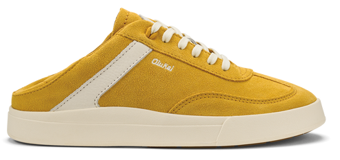 Yellow suede sneaker with white laces and sole, white stripe and the word "OluKai" written on the side.