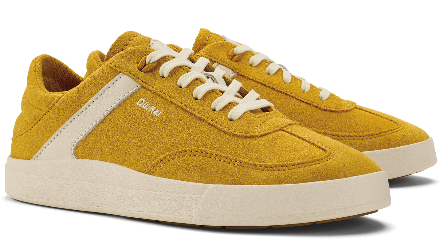Low-profile, yellow suede shoe with white laces and a white stripe.