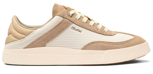 A beige sneaker with white laces and a white perforated fabric panel.