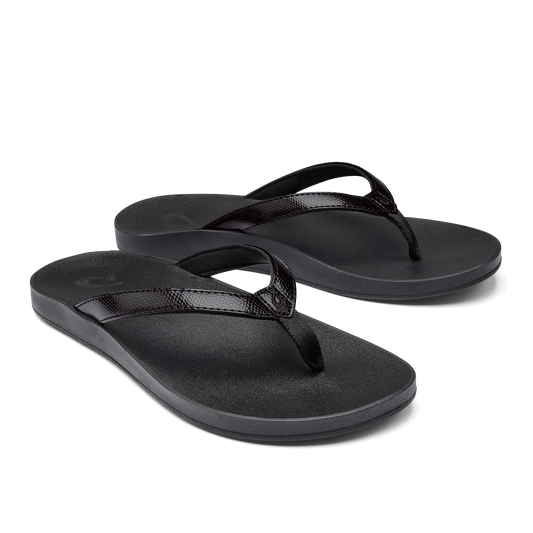 A pair of black flip-flops with shiny straps.
