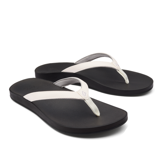 A pair of black flip-flops with white straps.